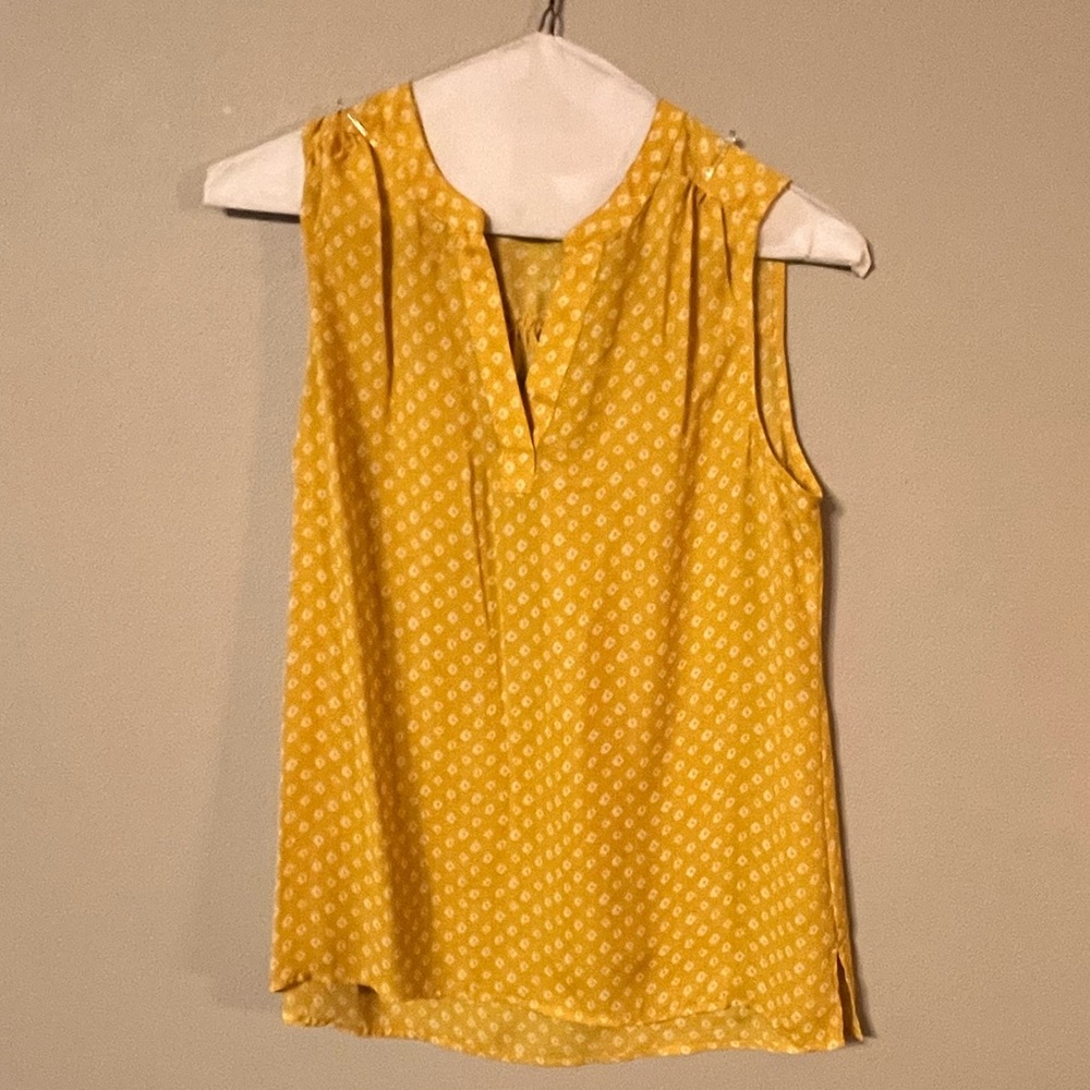 Yellow and white sleeveless blouse